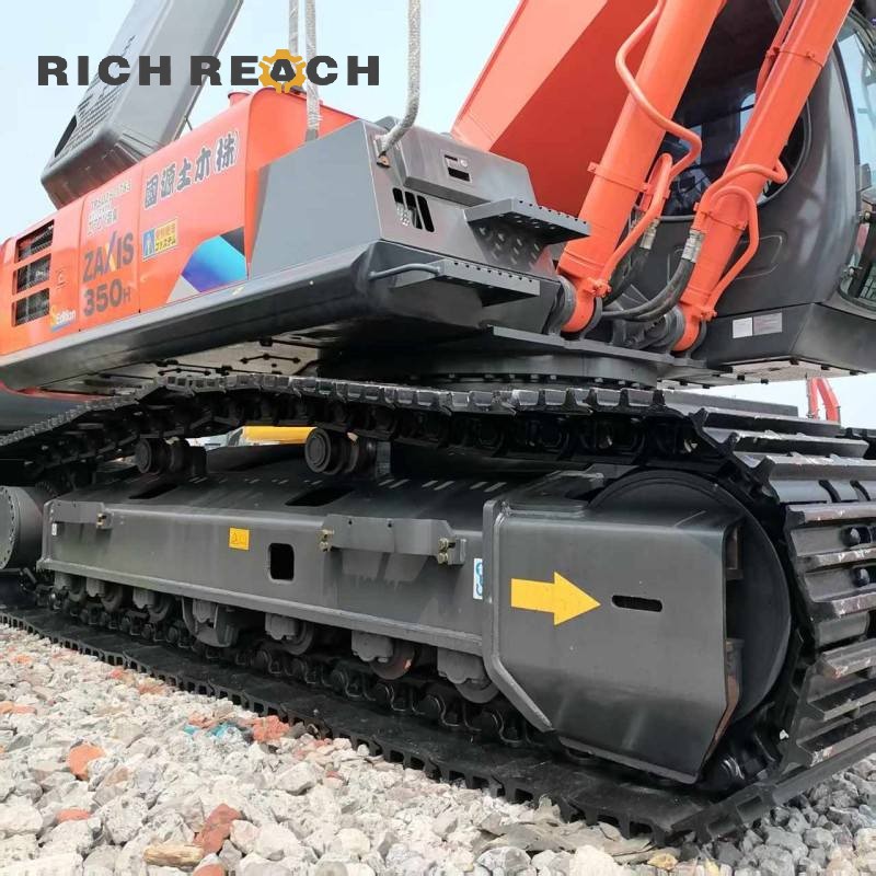Reinforced undercarriage and track shoes of a 2023 Hitachi ZX350-3G excavator, low hours, $30,750